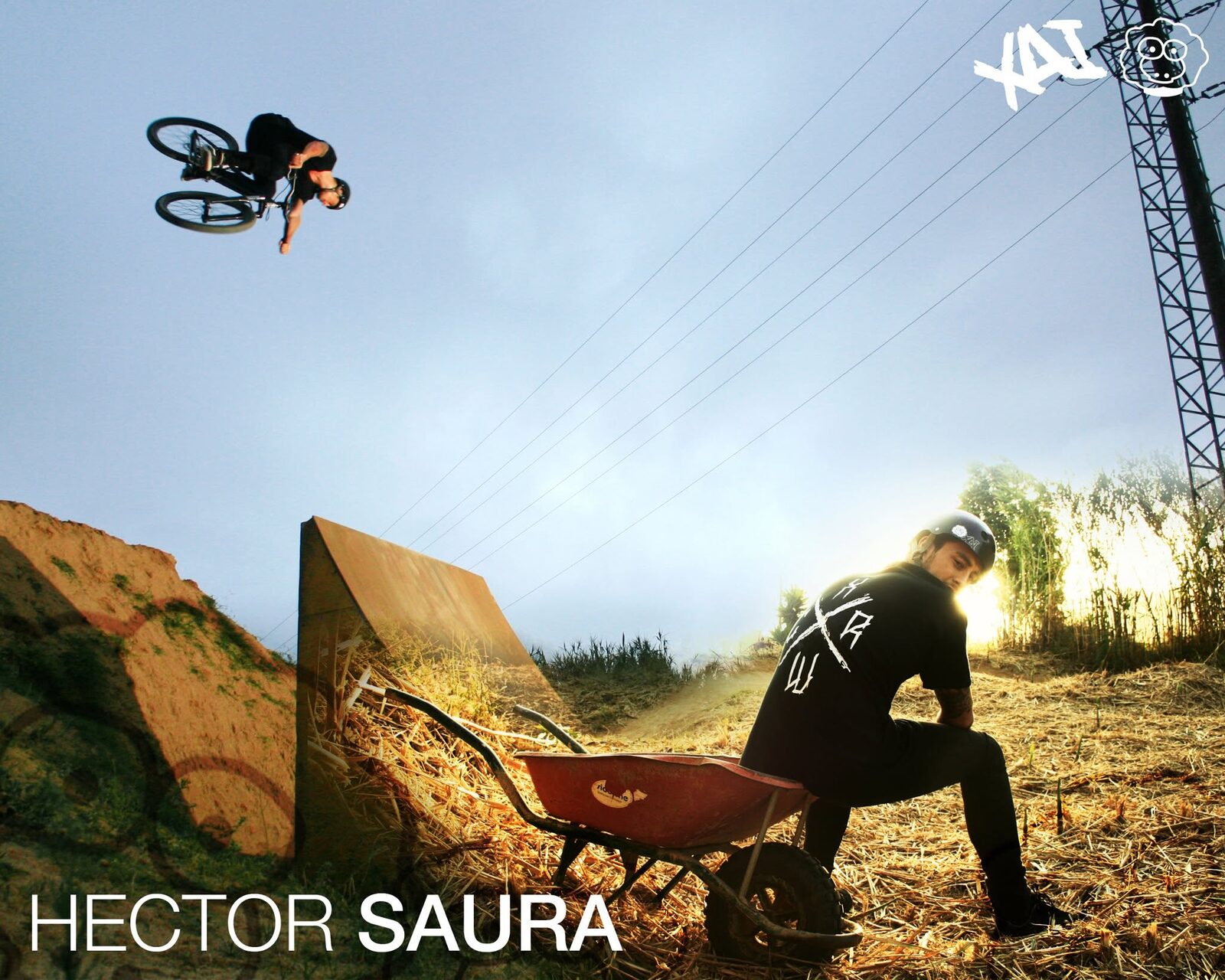XAI campaign: a rider mid-backflip over dirt jumps at sunset, with the XAI wordmark and sheep in the corner