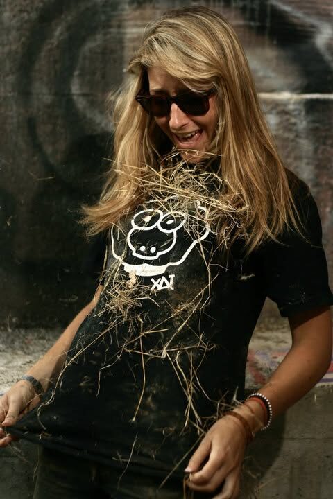 A girl in a black XAI sheep t-shirt, hair blowing across her face