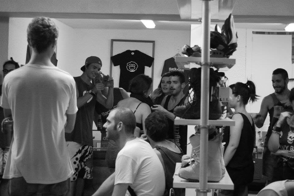Black and white photo of a crowd inside the shop