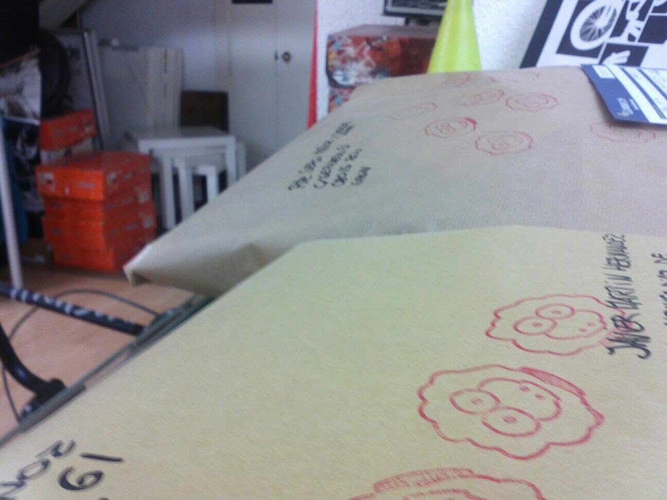 Parcels wrapped in kraft paper, stamped with red sheep and addressed by hand
