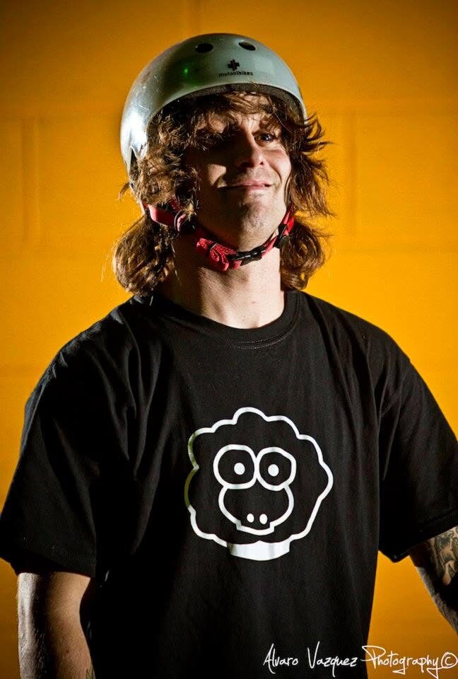 A rider in a black XAI sheep t-shirt against a yellow wall