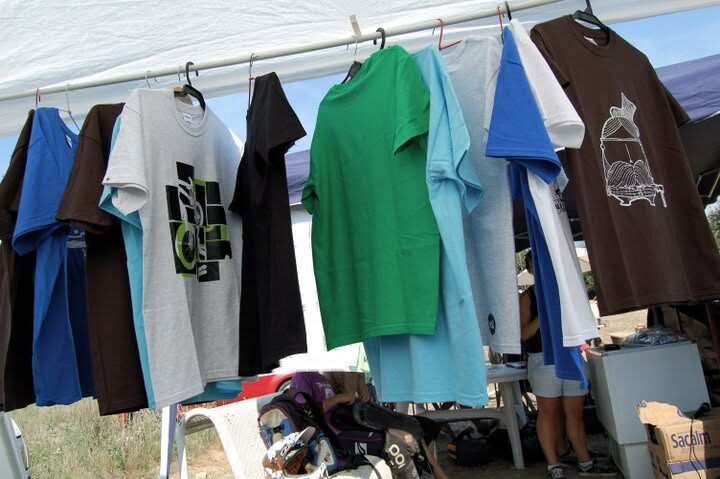 A market stall hung with XAI t-shirts in many colours