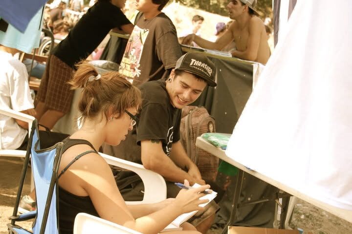 Two people working the XAI stall, sitting behind the table