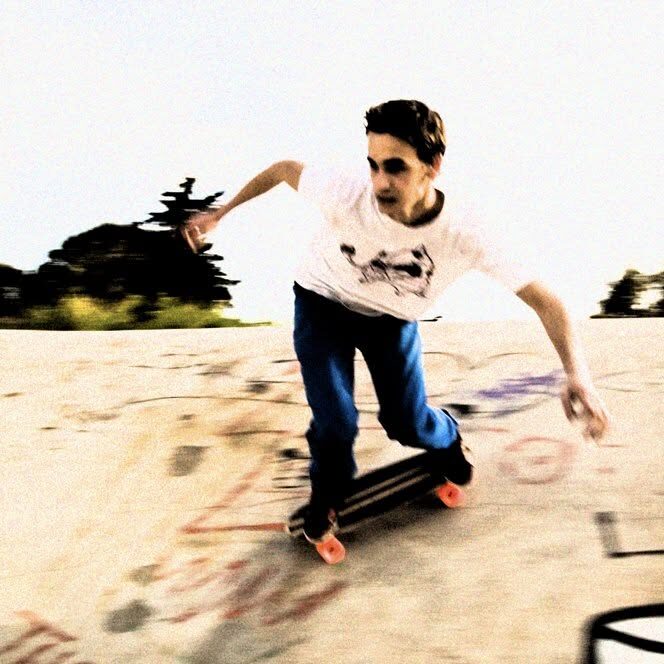 A skateboarder pushing along a concrete bank