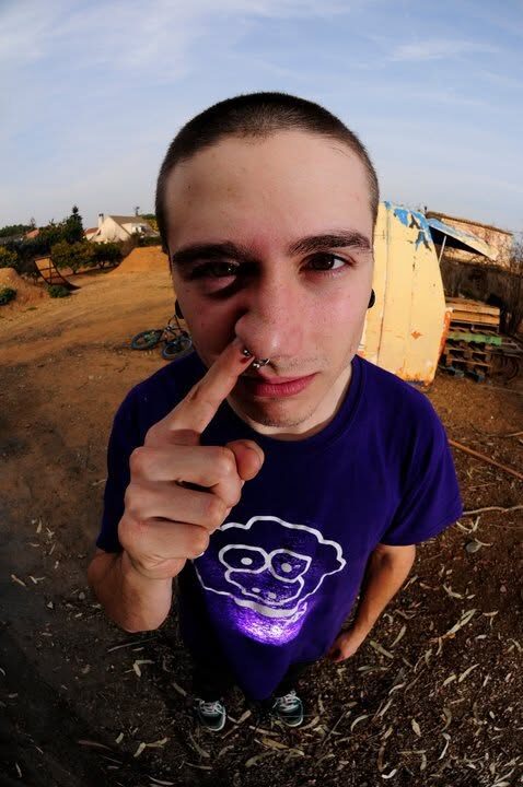 A close-up of a rider in a purple XAI sheep t-shirt