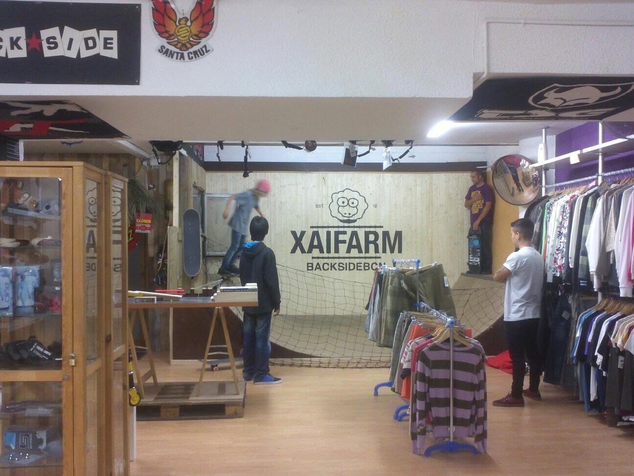 The XAI FARM and Backside BCN shop interior, rails of clothing and the ramp behind