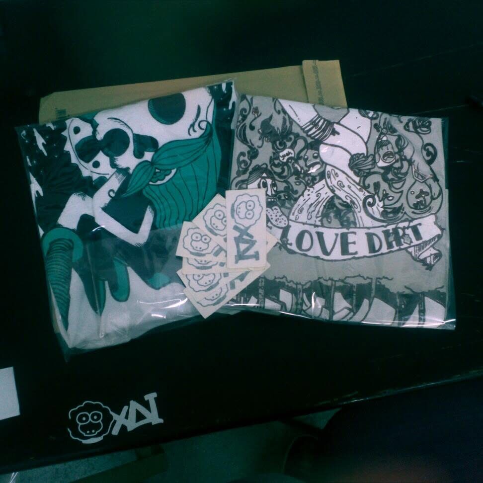 A printed garment reading LOVE DIRT with sheep graphics